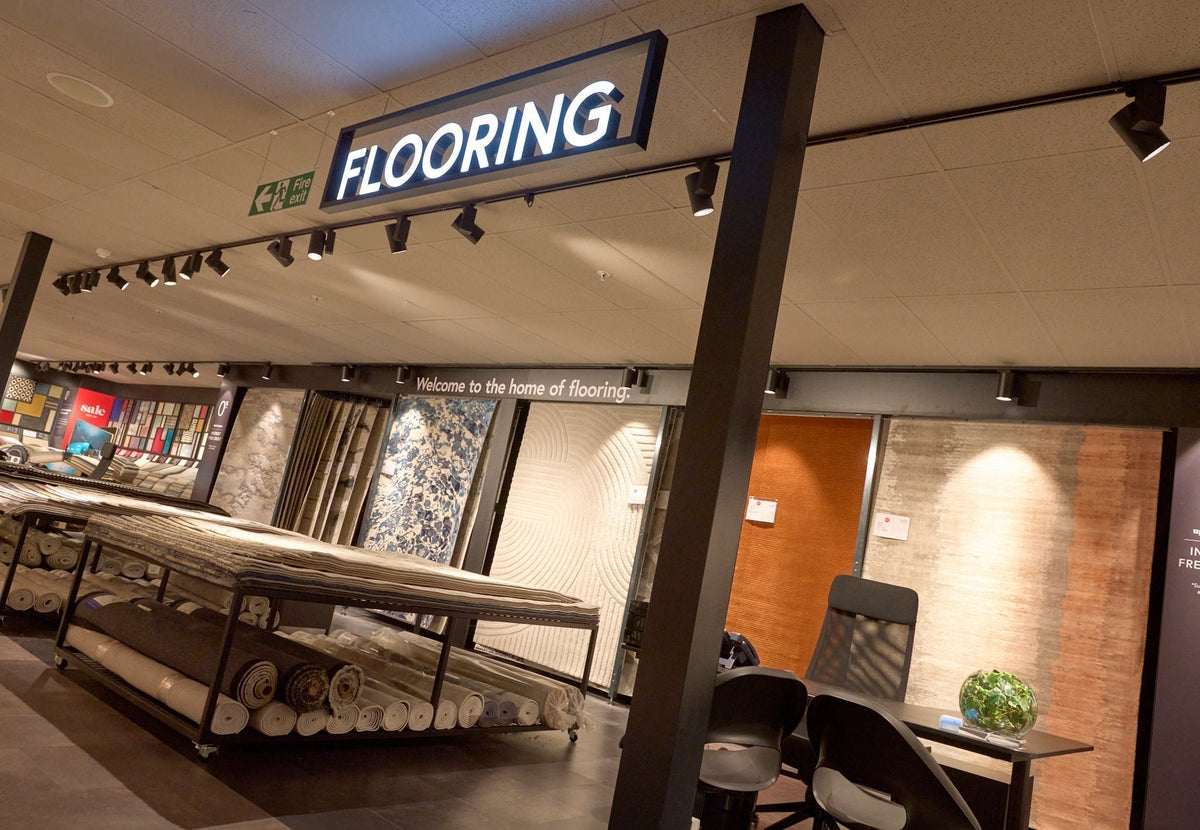 Flooring department with rugs featured across the wall