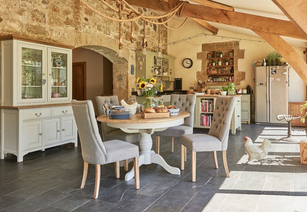 country inspired dining space, wooden dining table with fabric chairs, with wooden sideboards