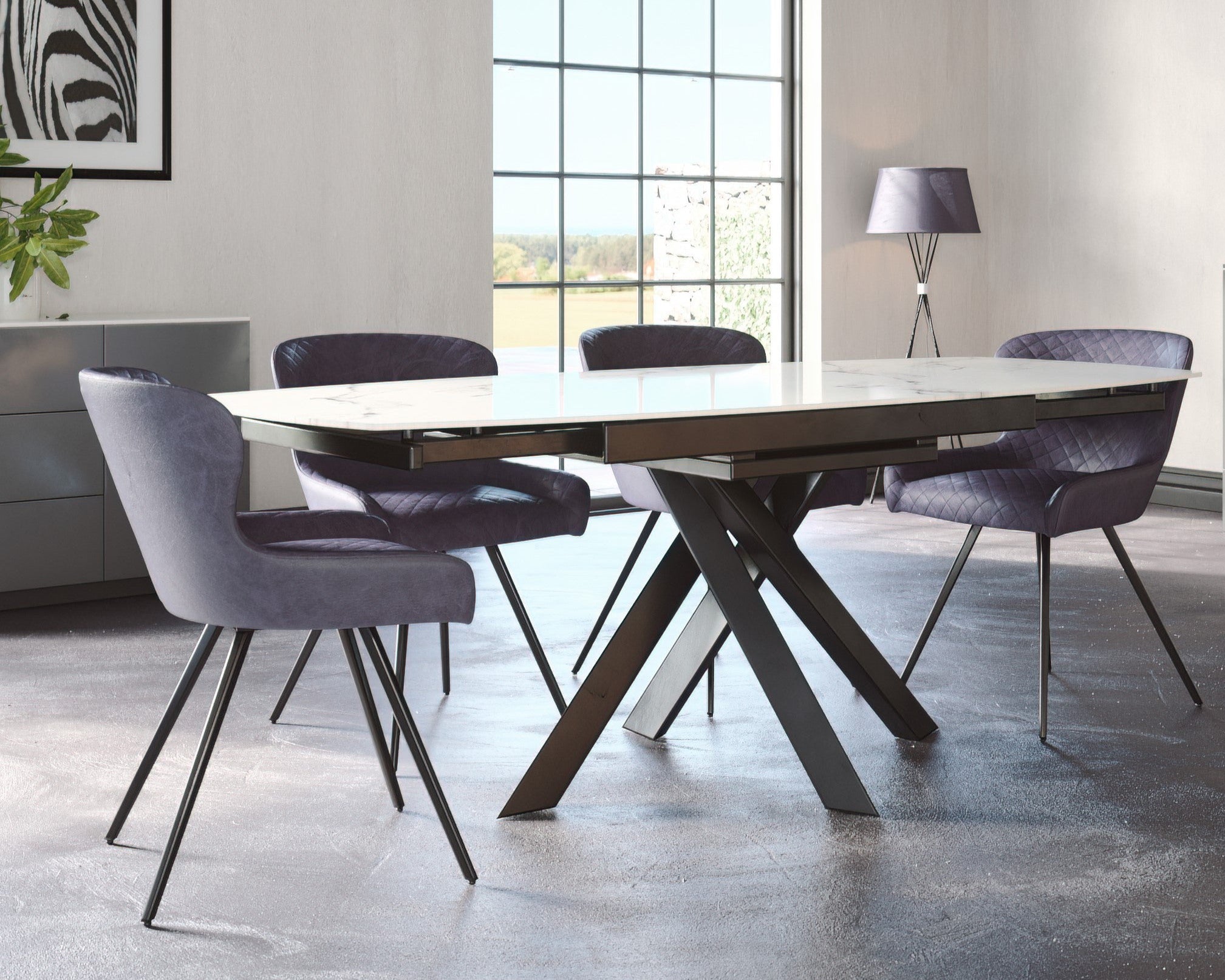 Modern dining room with a long dark wooden table and purple chairs.