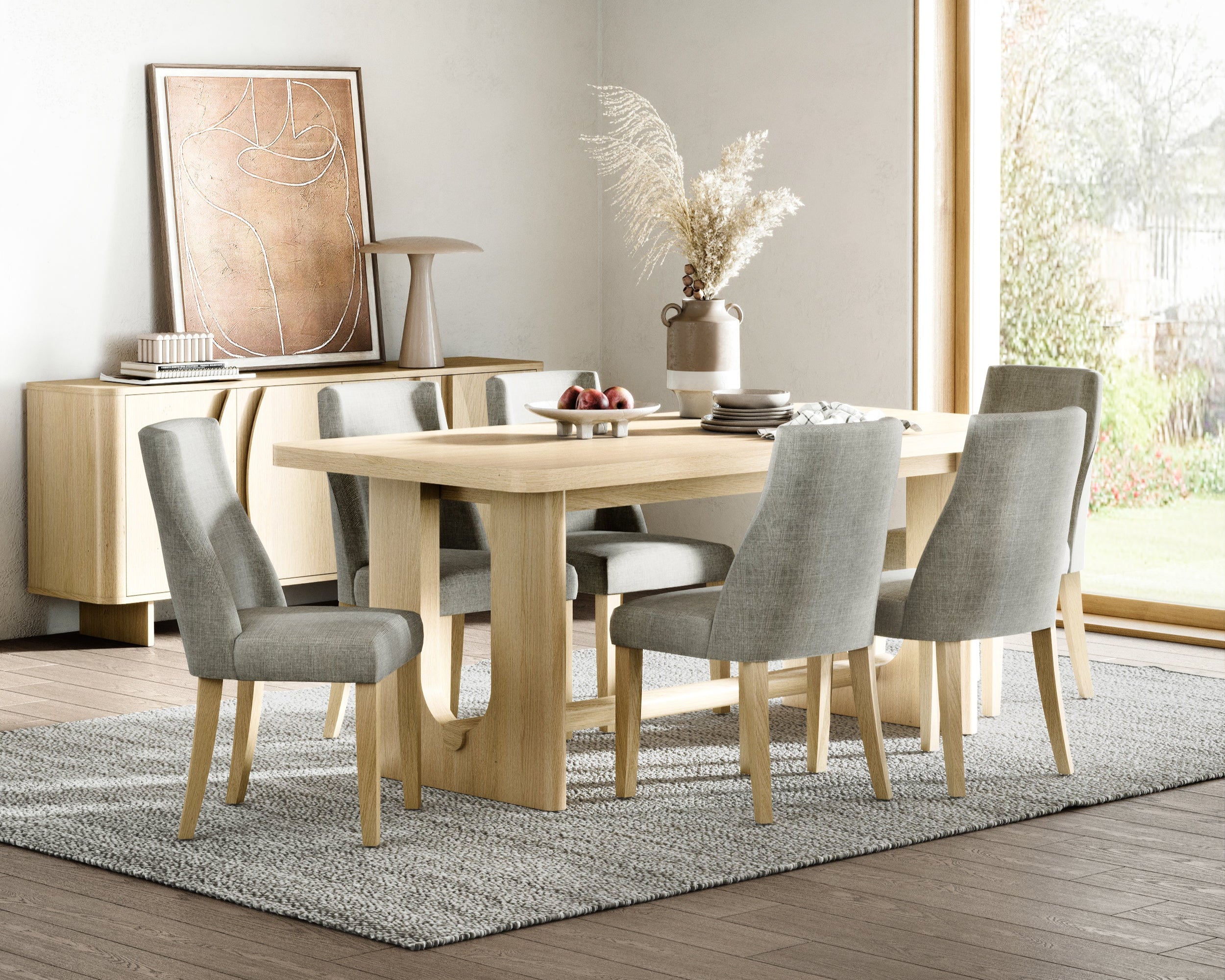 Dining room with wooden table and chairs, sideboard and large window.