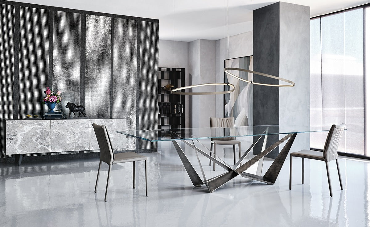 Modern dining room with a glass table and stylish chairs.