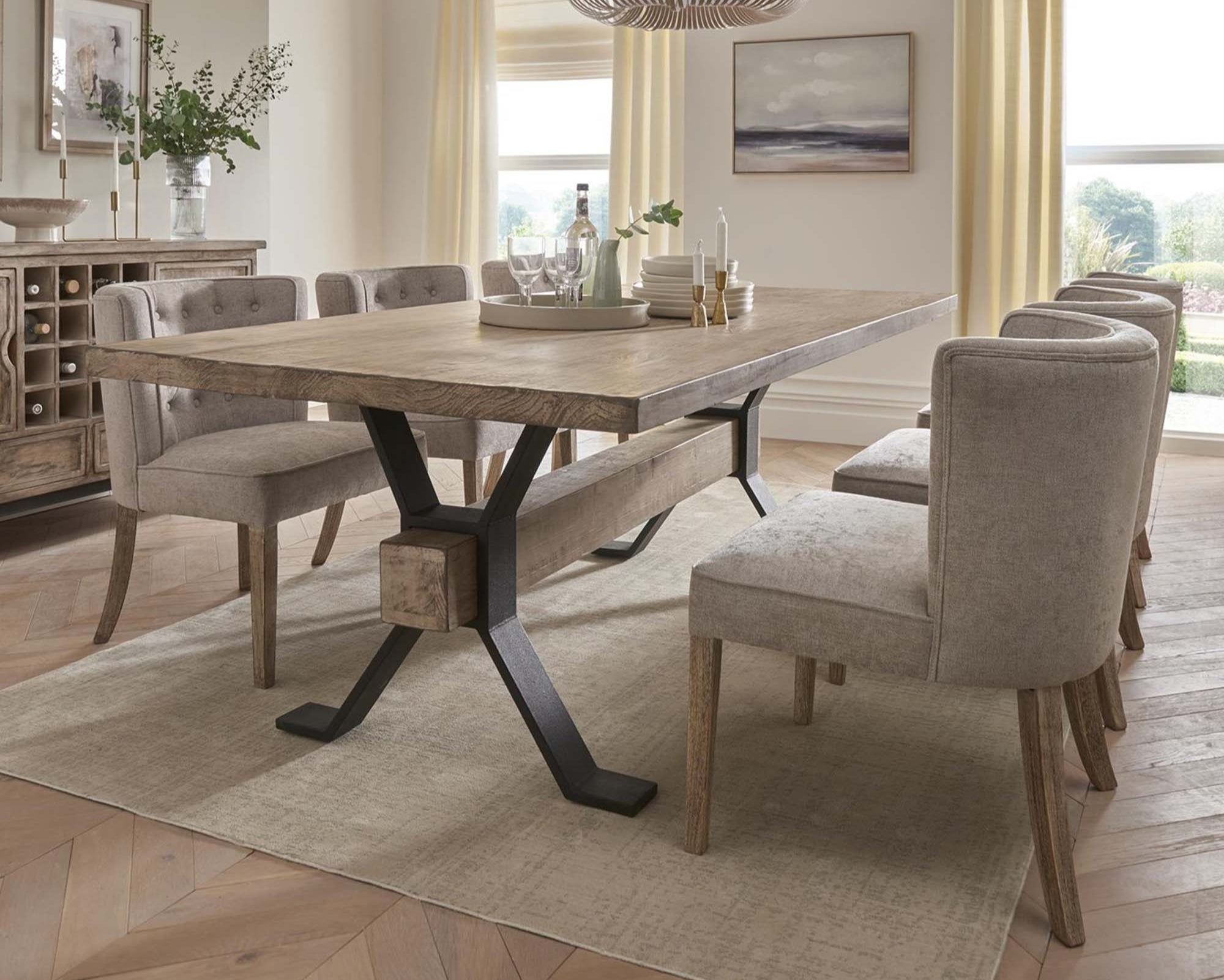 Dining room with a wooden table and chairs in a well-lit room.