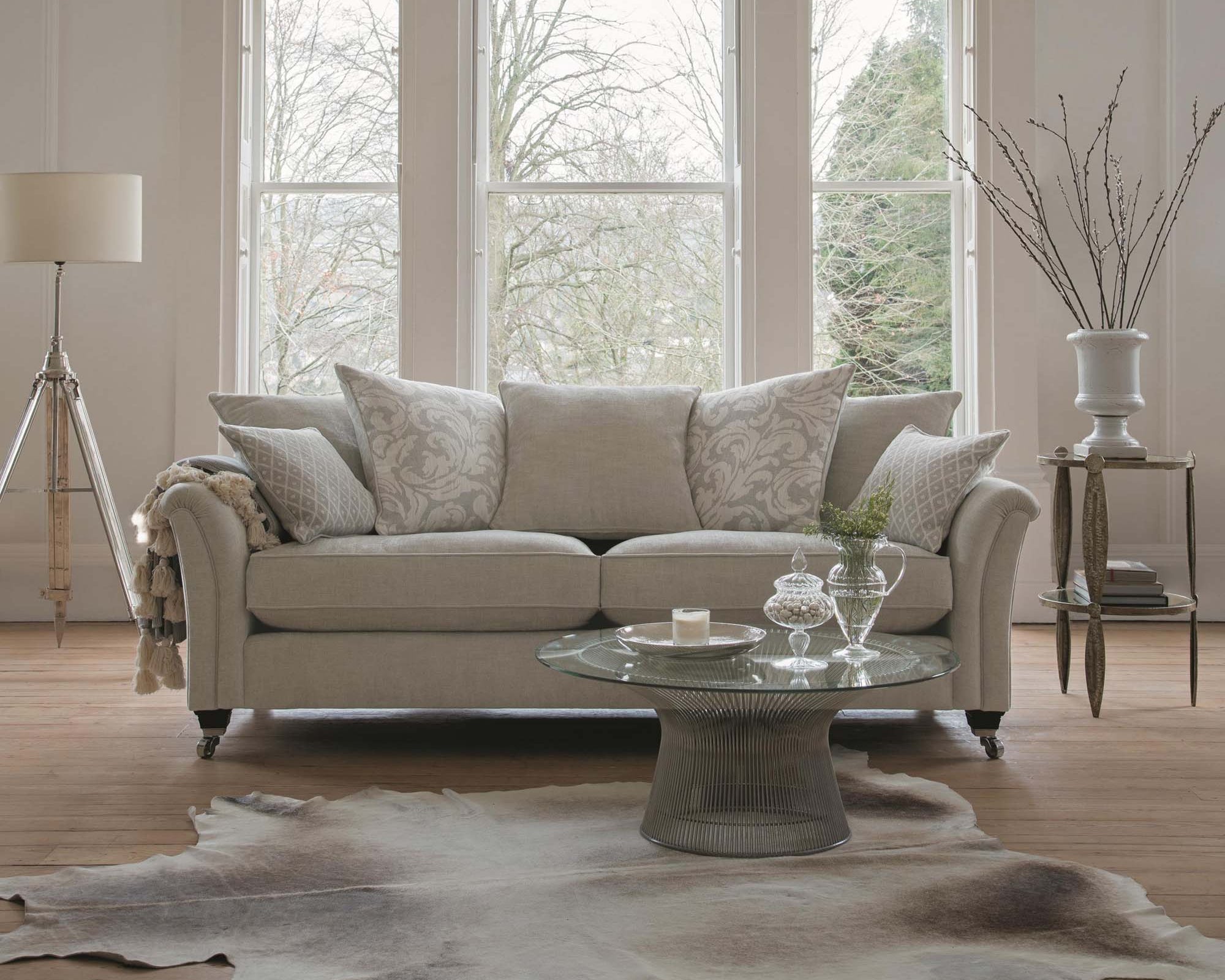 Living room with a beige sofa, coffee table, and decorative elements.