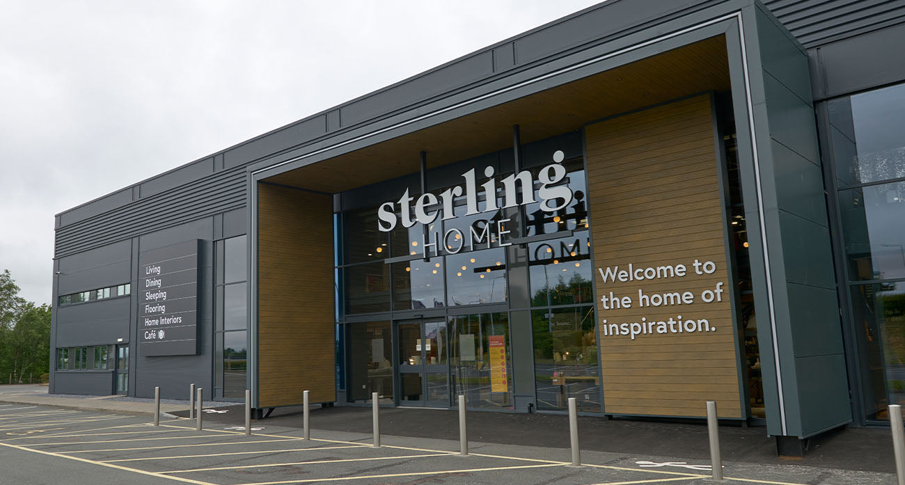 Building with 'Sterling Home' sign and 'Welcome to the home of inspiration.' text
