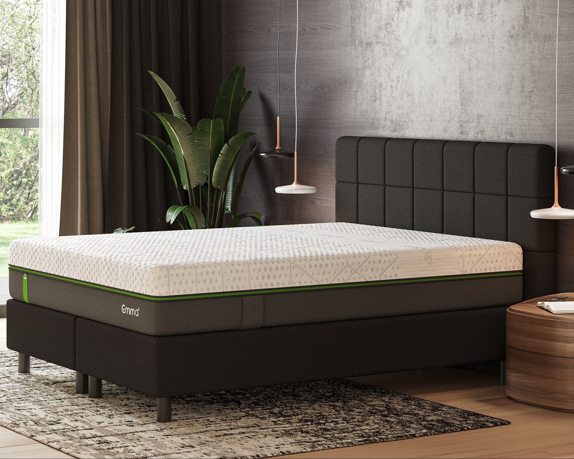 Emma mattress on a bed frame in a bedroom setting with decor elements.