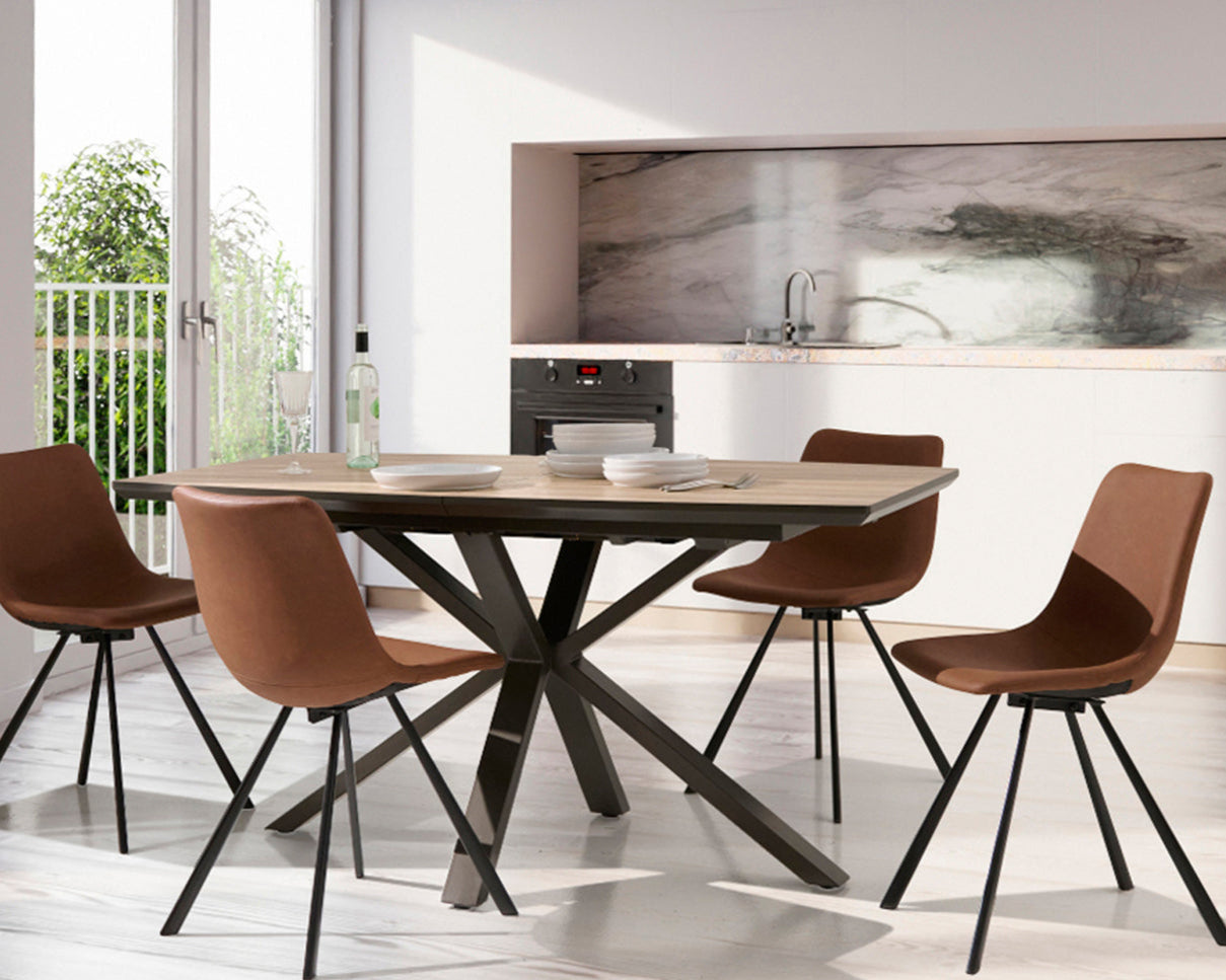 Dining area with a wooden table and four brown chairs in a modern kitchen.