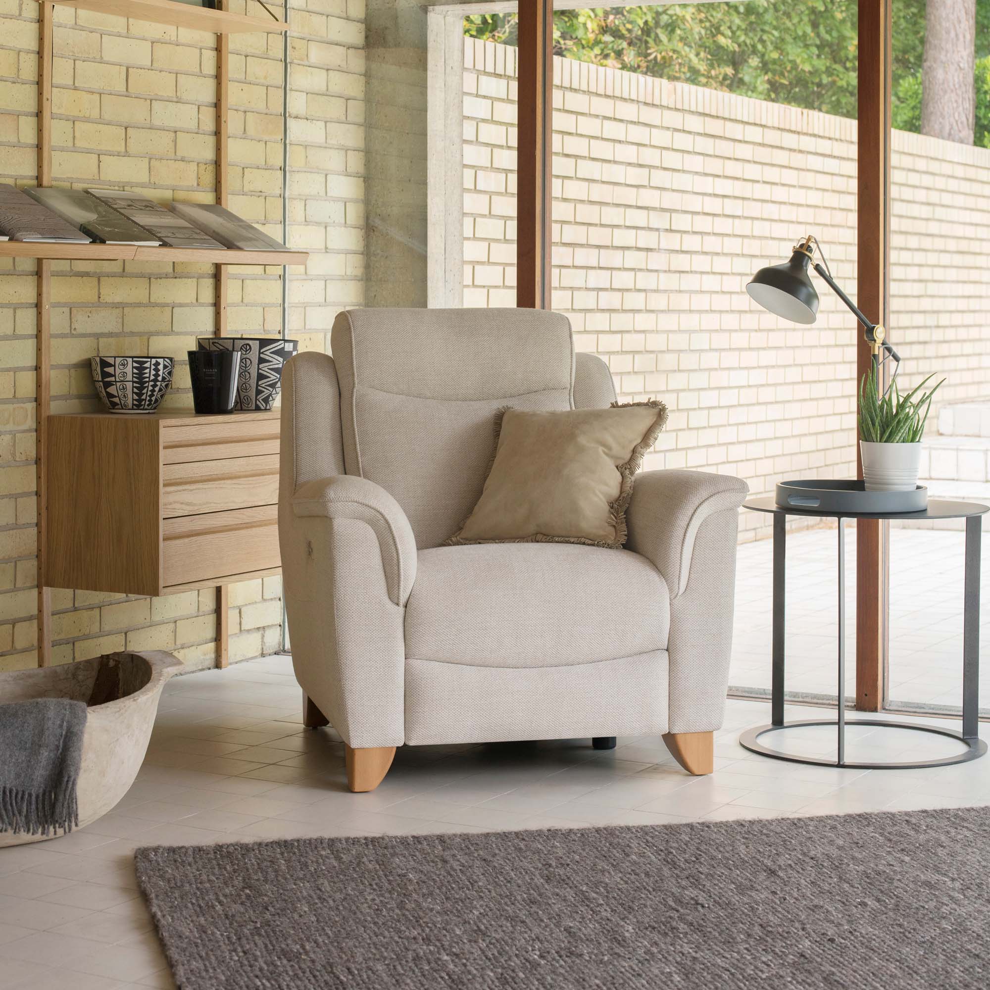 Beige armchair with a pillow in a modern living room setting