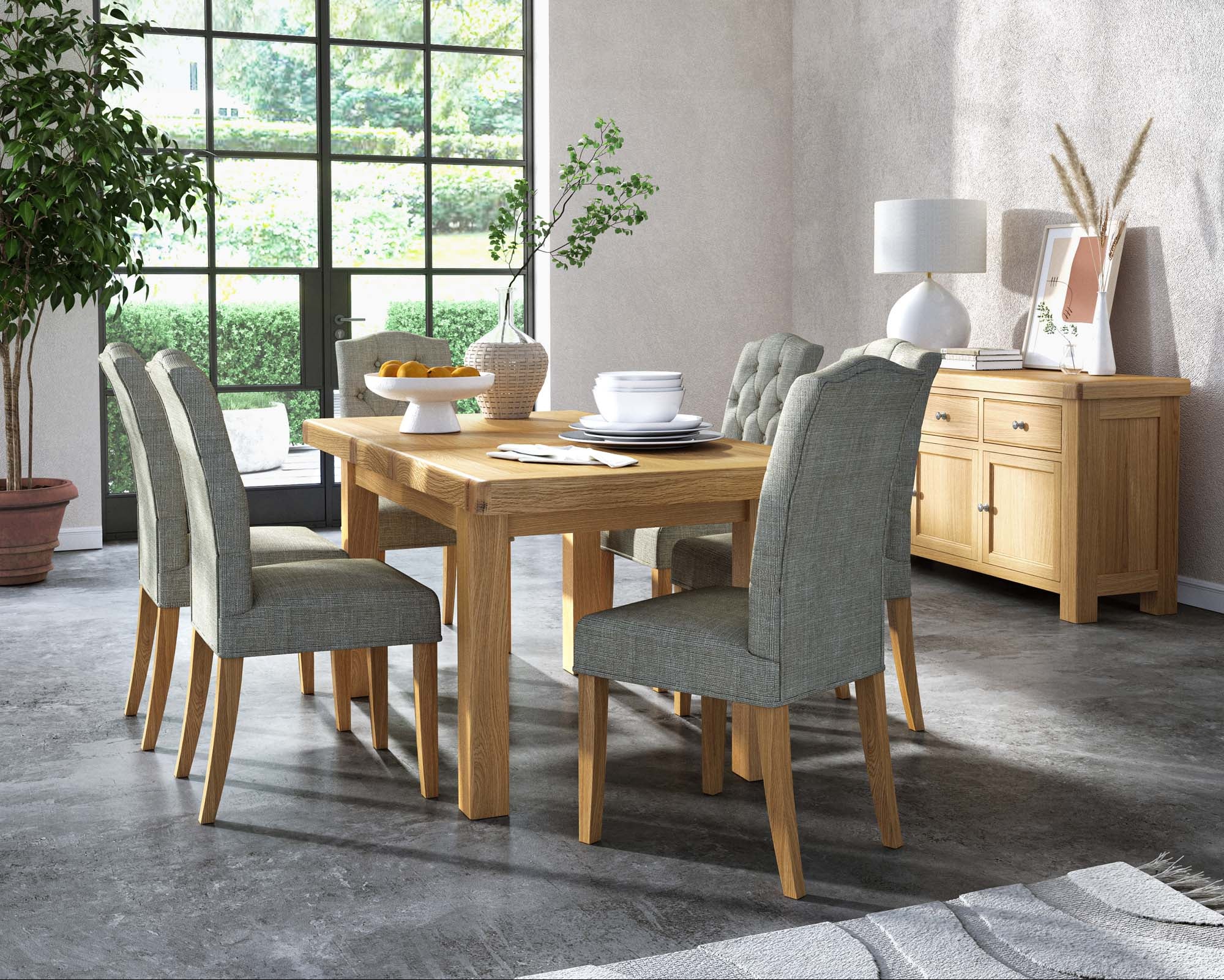 Dining room with wooden table and grey chairs near a large window.