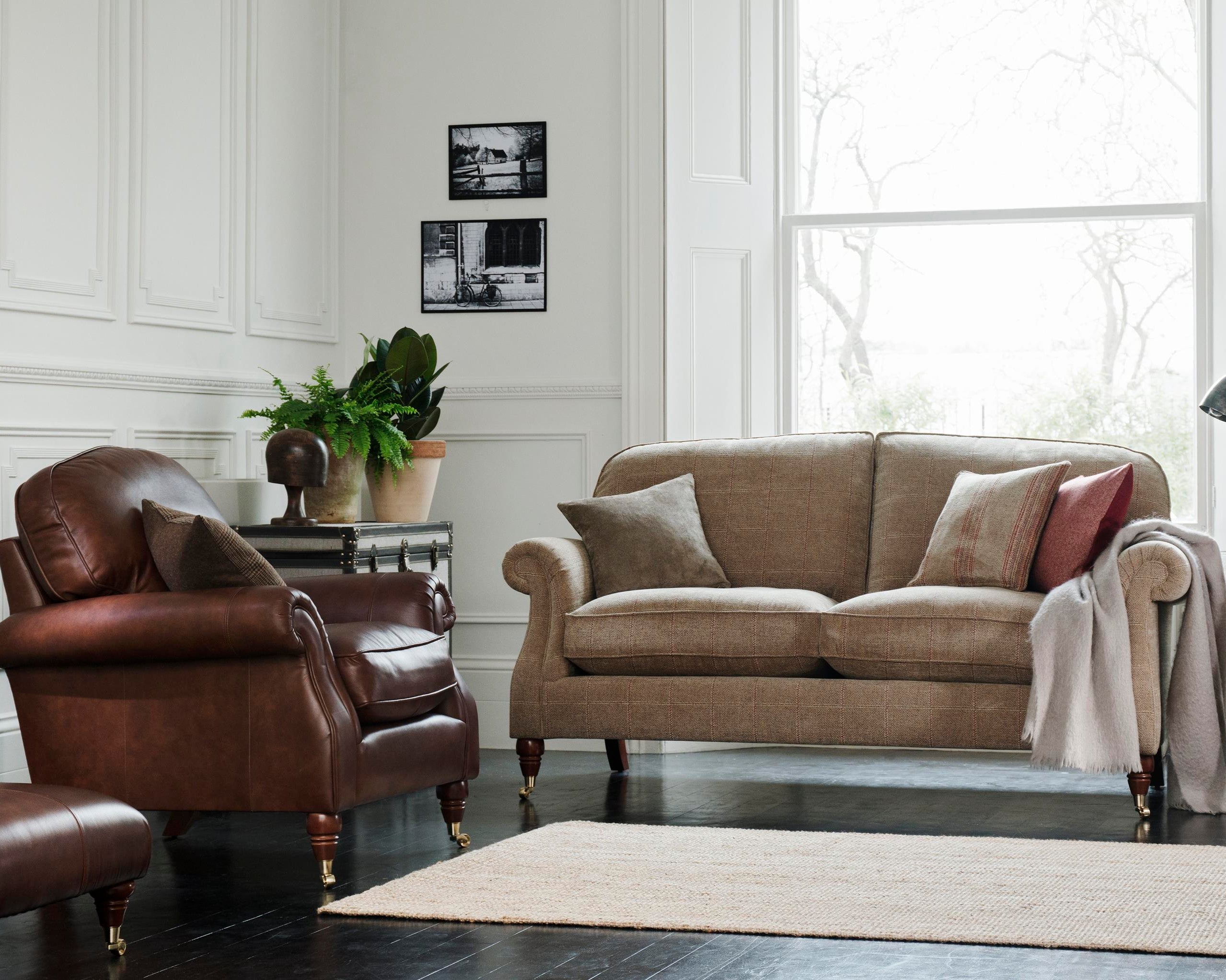 Living room with a Parker Knoll brown leather armchair and beige sofa.