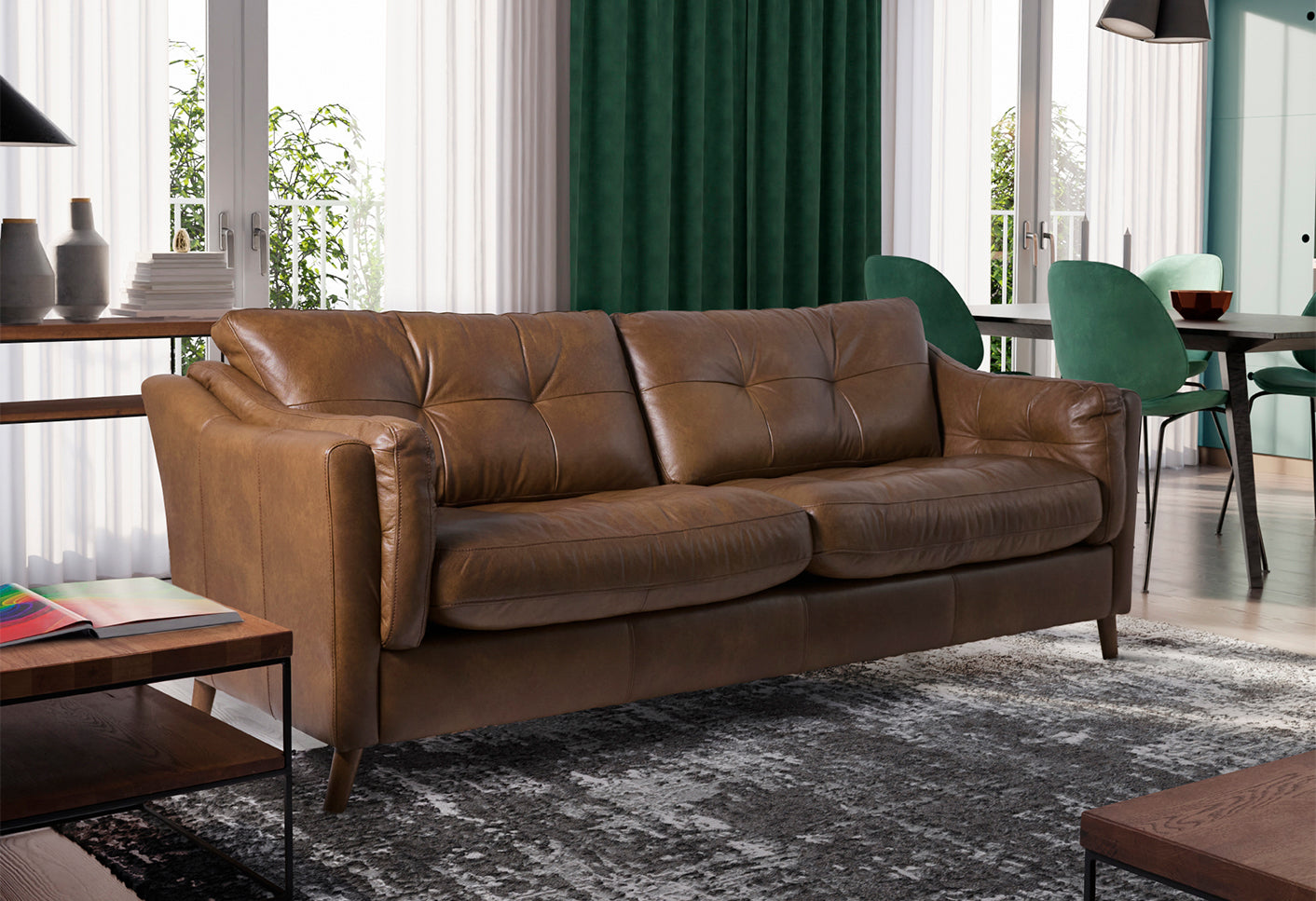 Brown leather sofa in a living room setting with green chairs and a coffee table.