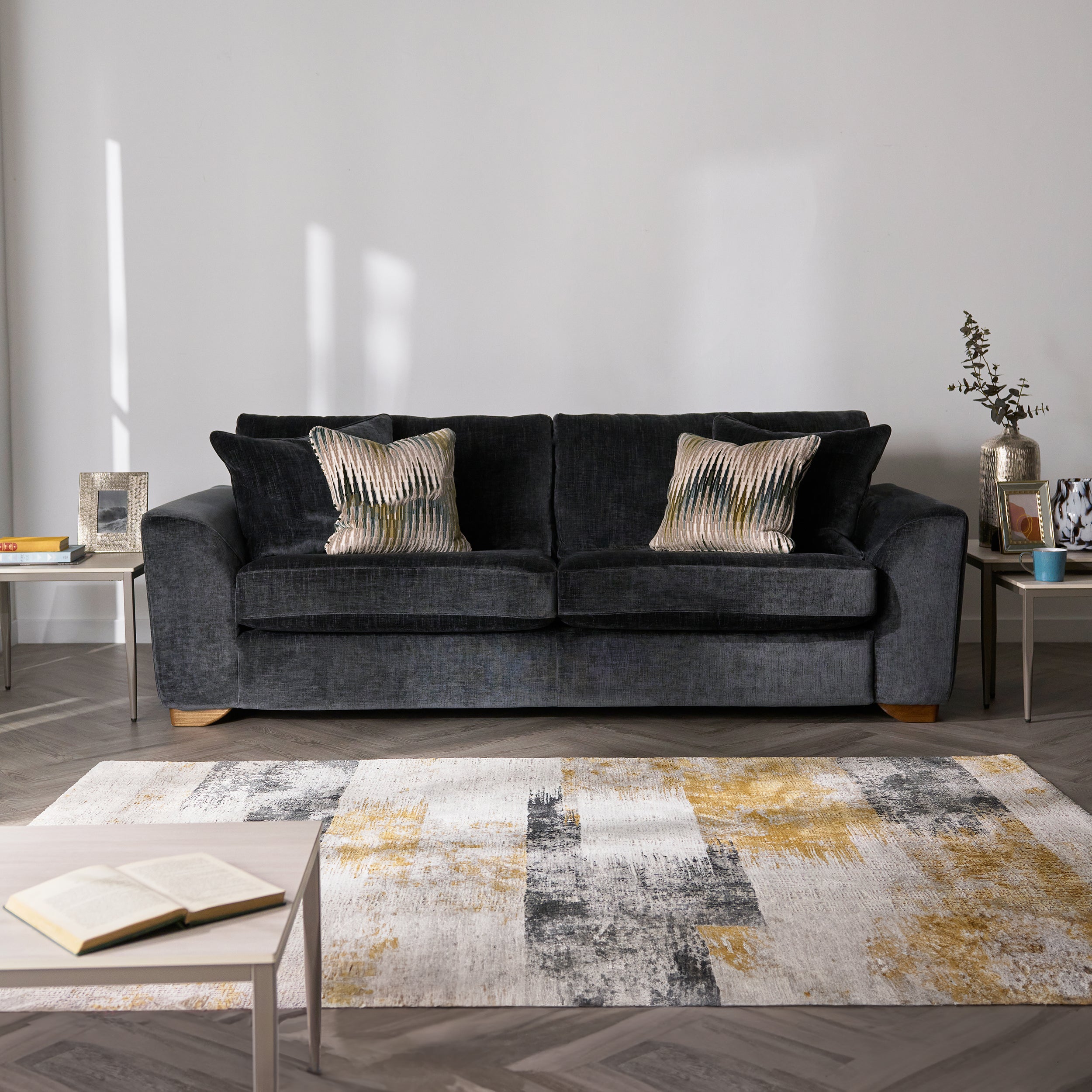 Grey sofa with patterned cushions in a living room setting
