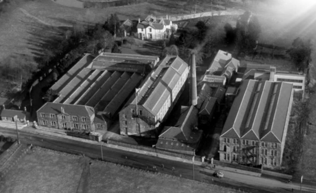 Aerial view of a Sterling Home in 1973 with large buildings and a prominent house.