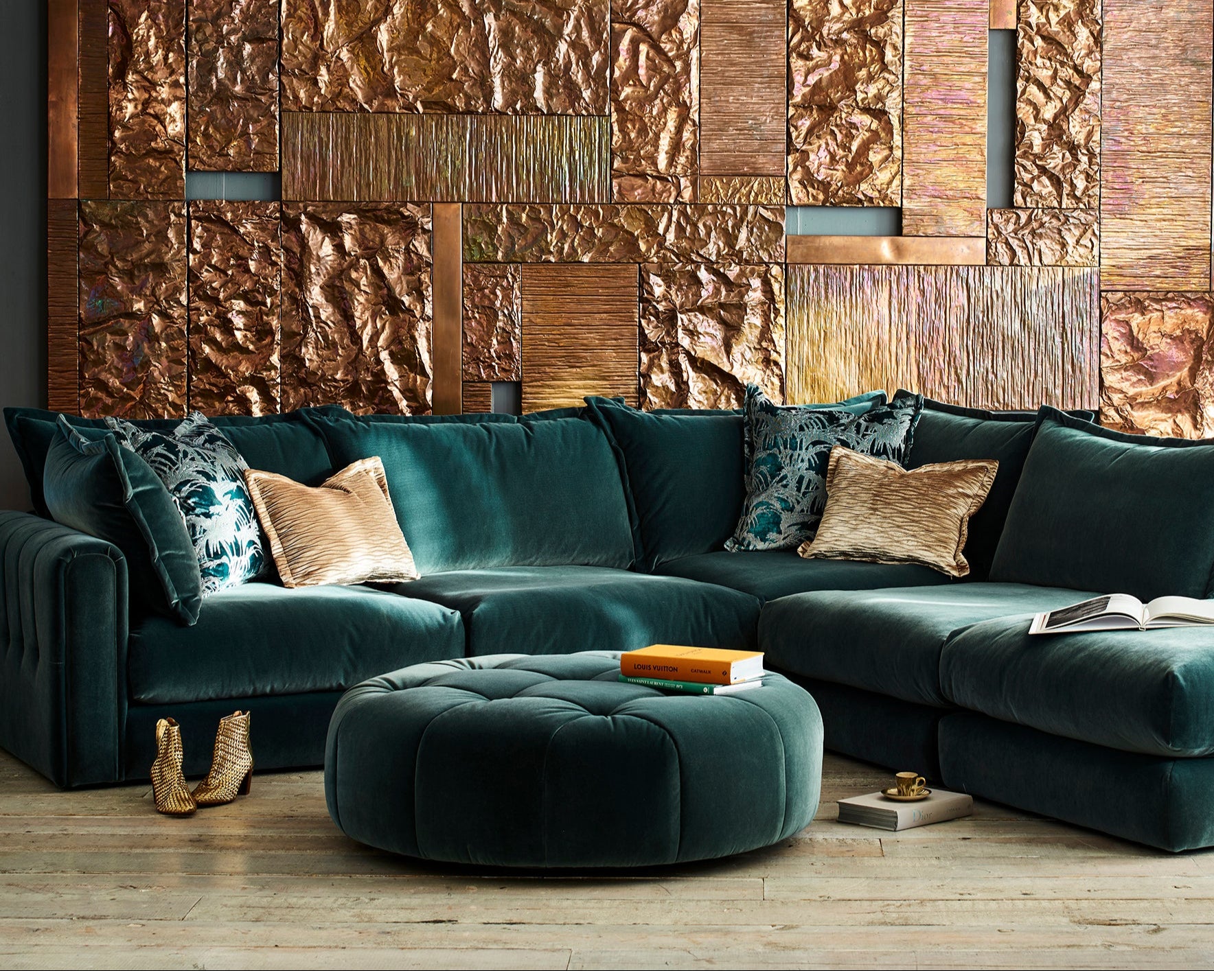 Modern living room with a dark green summerton corner sofa and textured wall paneling.