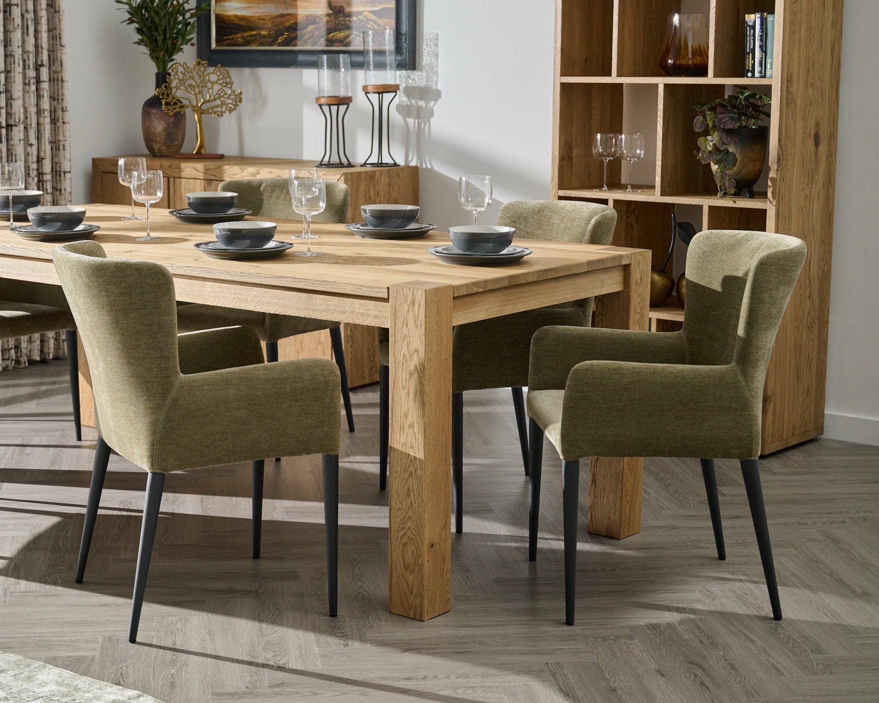 Dining room with wooden table and chairs in a well-lit room.