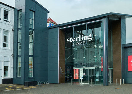 Modern building with 'sterling HOME' sign on a clear day