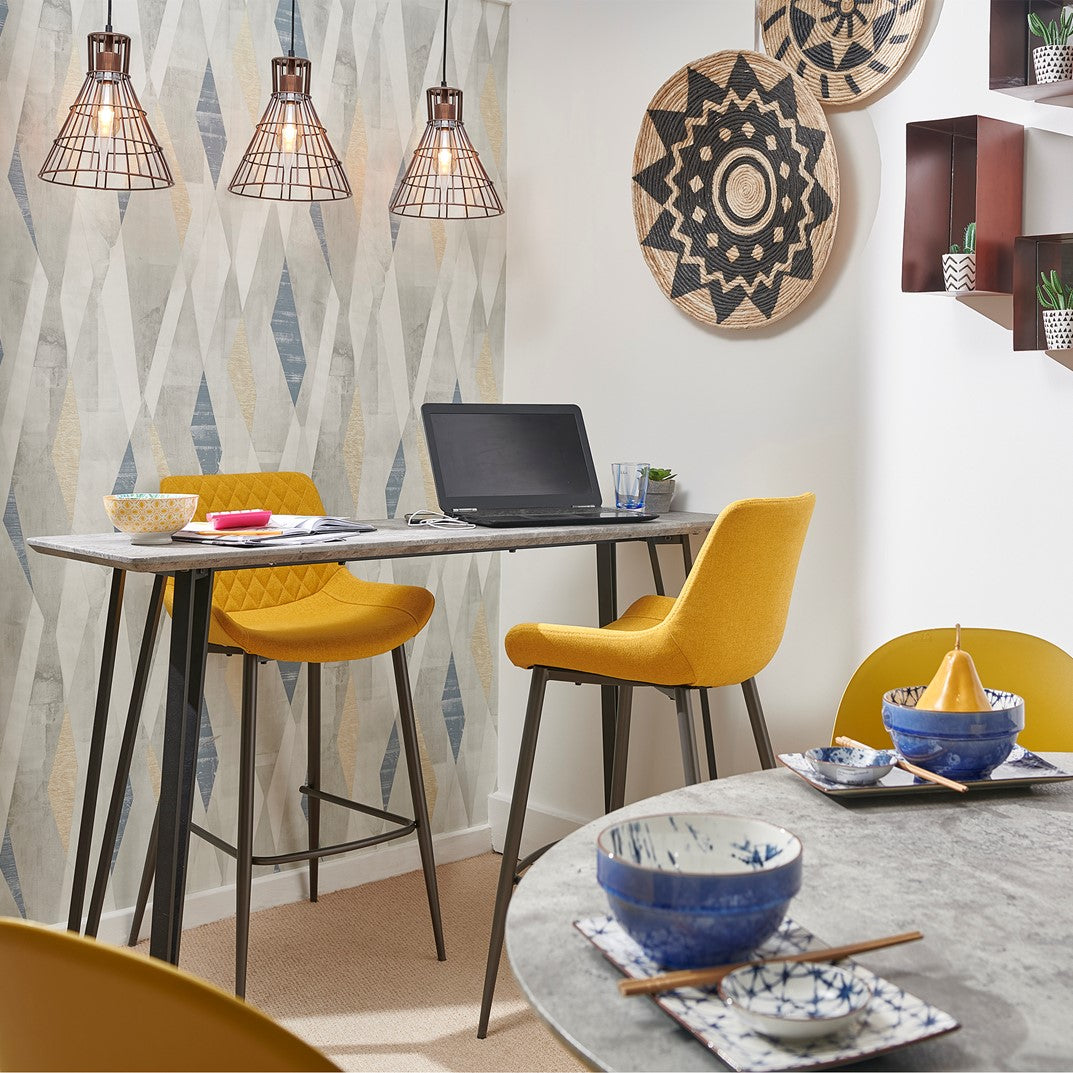 Dining area with bar table and yellow chairs, with dining accessories 