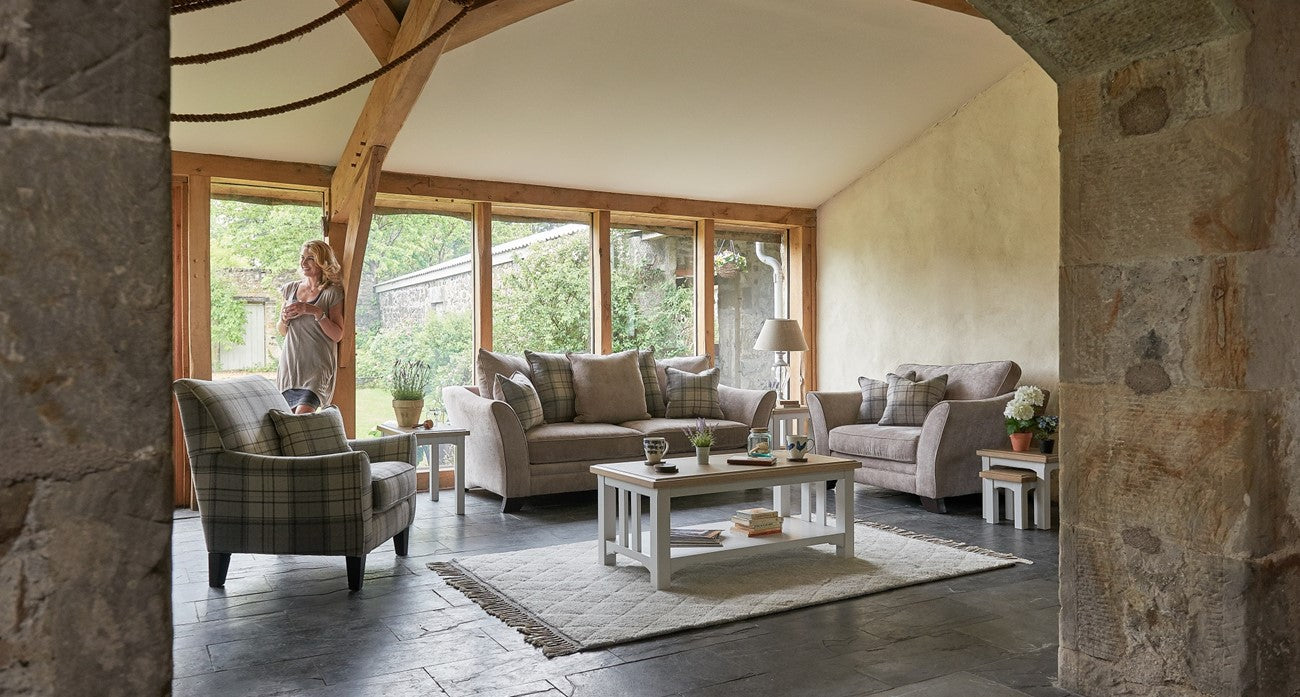 3 seater sofa, armchair and accent chair in a barn inspired living room, with a wooden coffee table 
