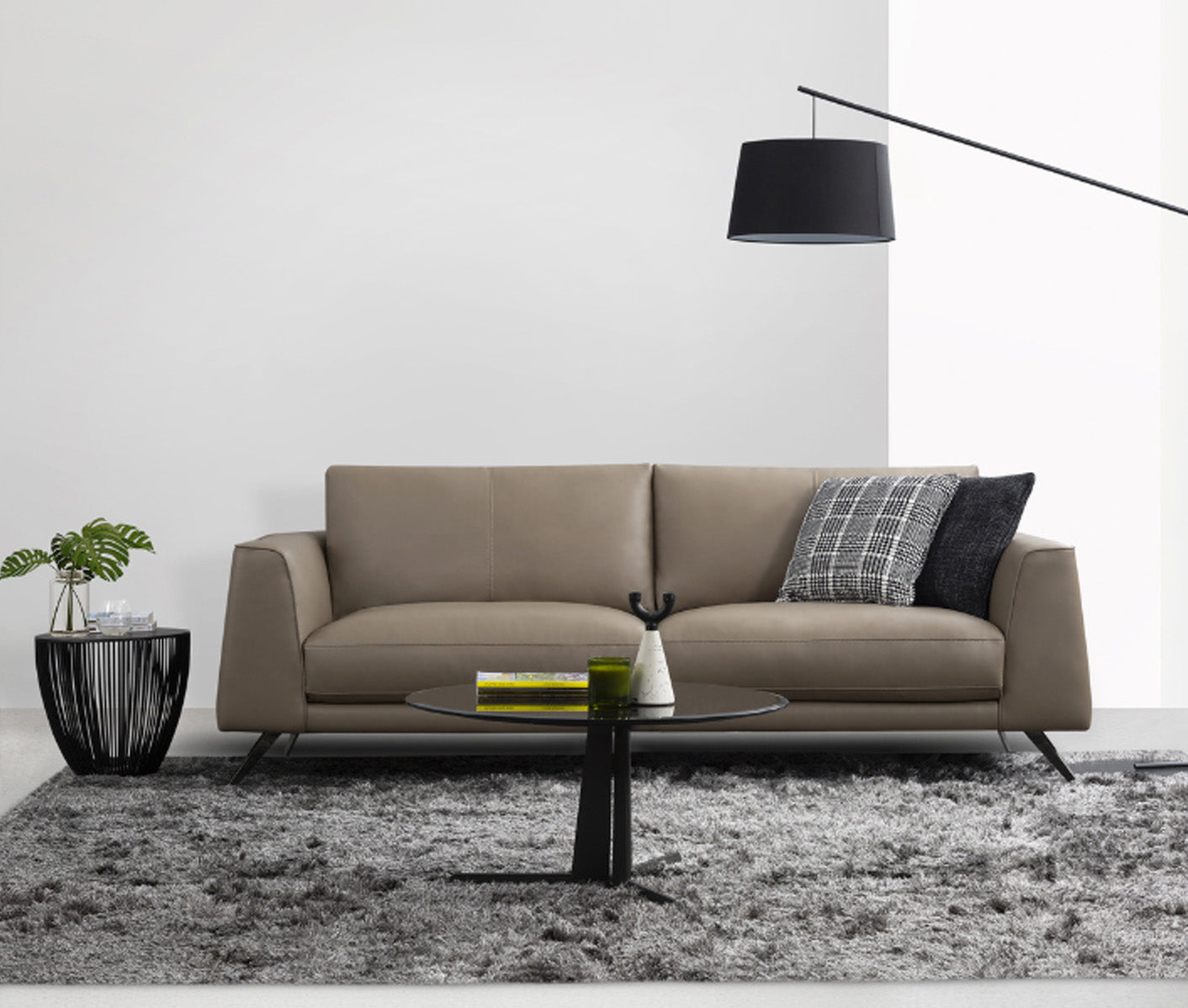 Modern living room with a beige sofa, coffee table, and decorative items.