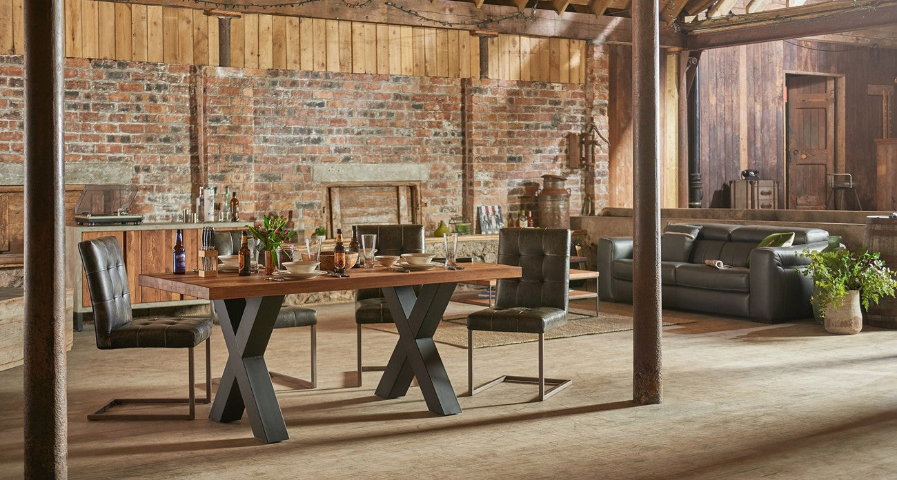 Industrial dining set with 4 chairs in a rustic setting. 