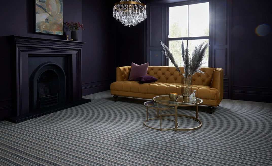 Luxurious living room with a yellow fabric sofa, and a grey striped carpet.