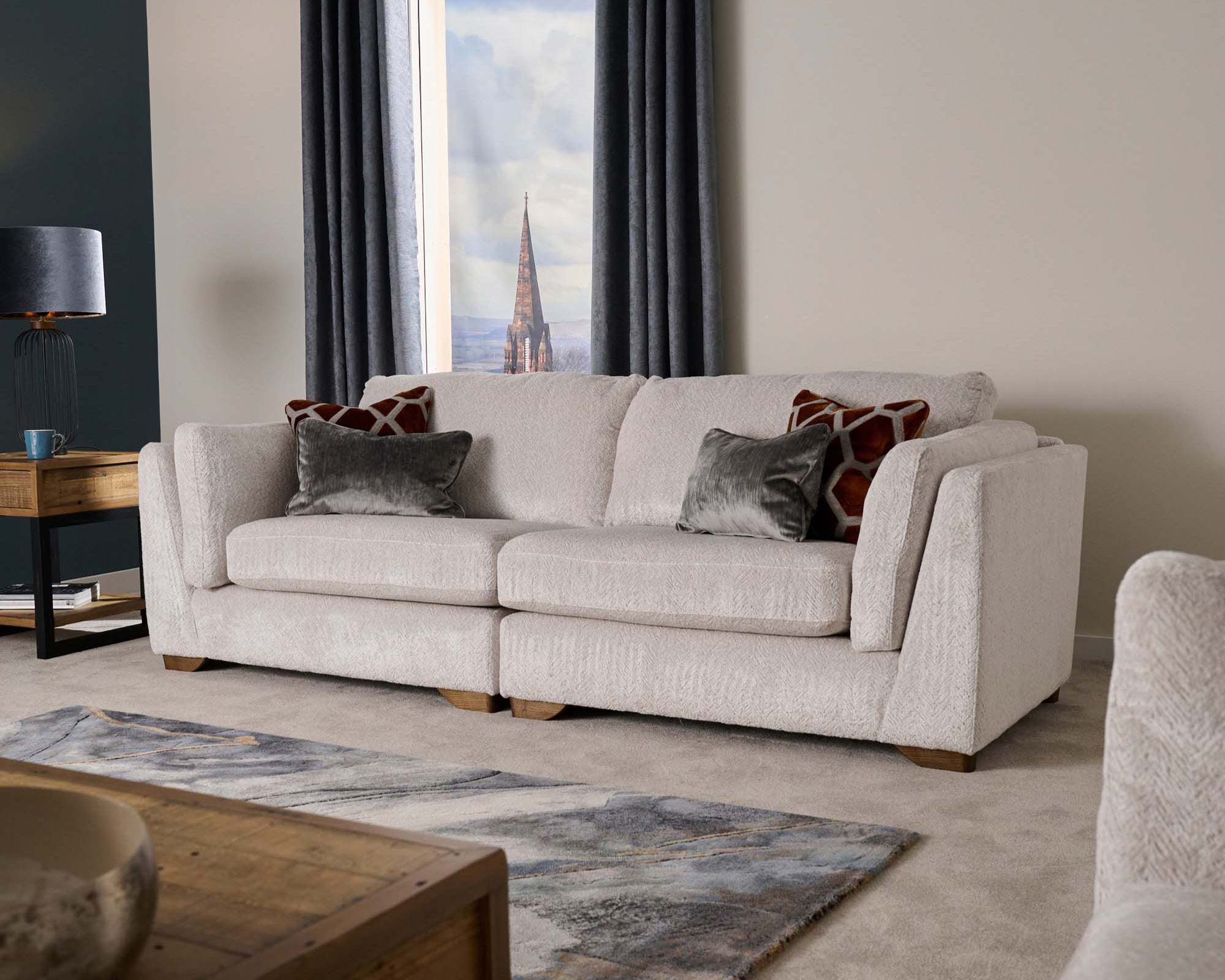 Living room with a beige sofa, wooden coffee table, and decorative pillows.