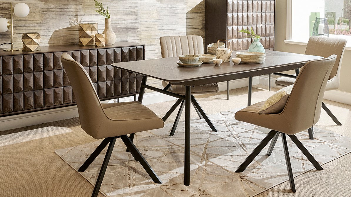 Dining room with black dining table and cream leather chairs in a stylish interior setting.