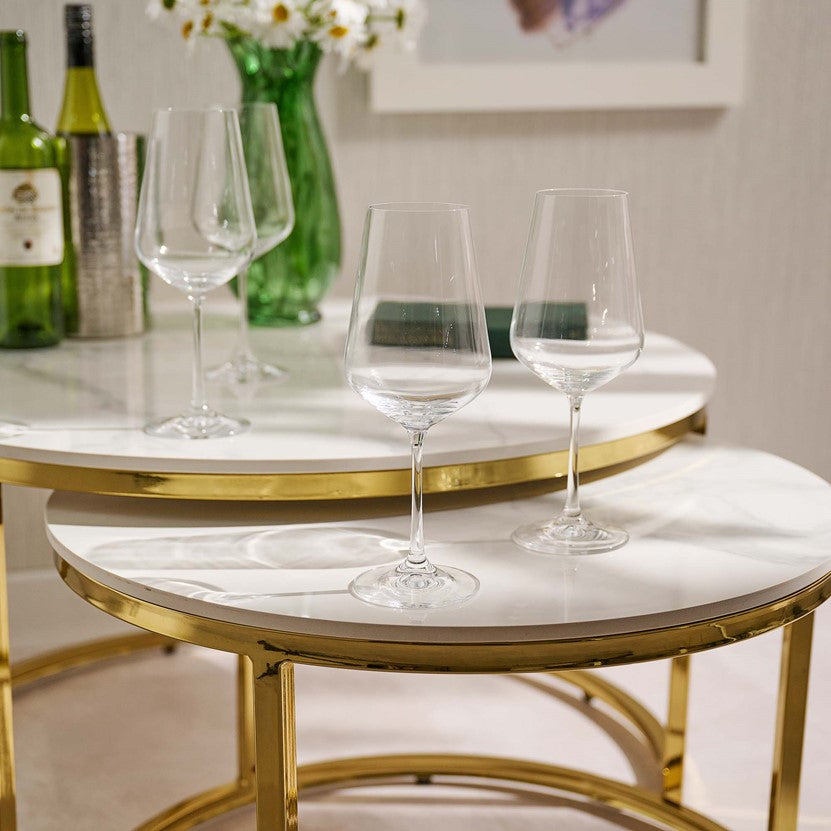 Wine glasses on a marble table with gold frame