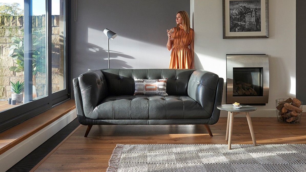 Modern living room with a grey sofa, coffee table, and decorative items.