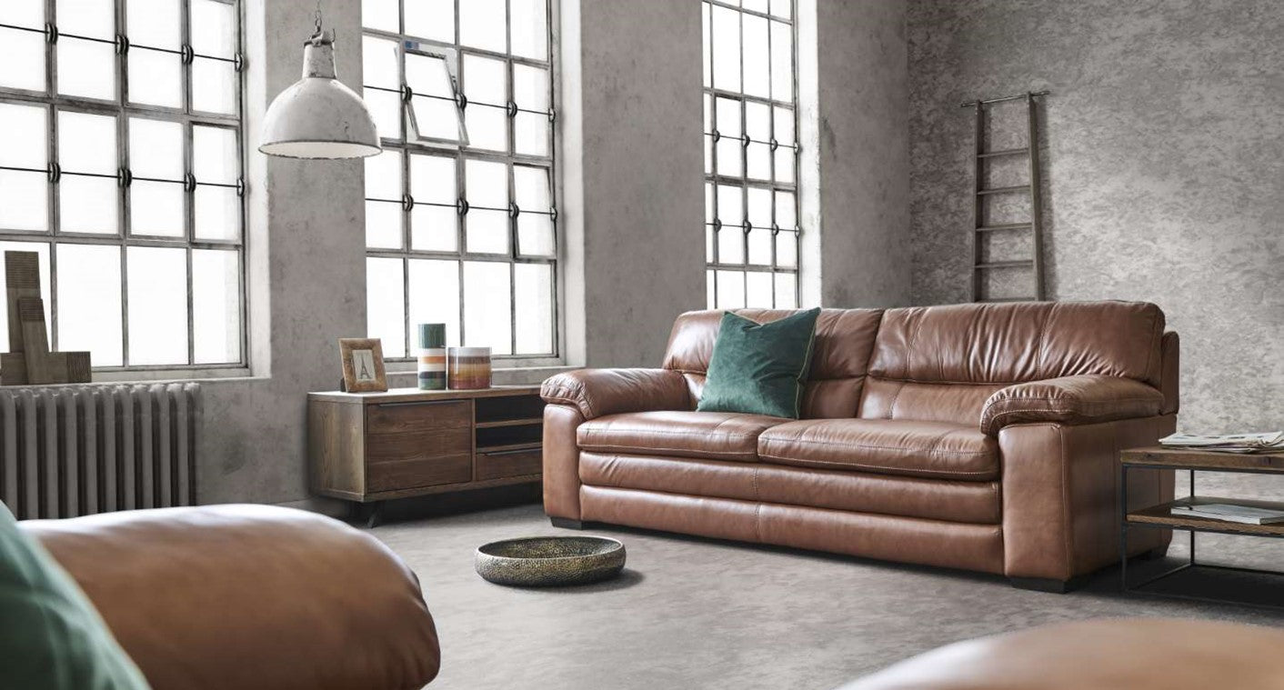 Two seater brown leather sofa in a modern living room.