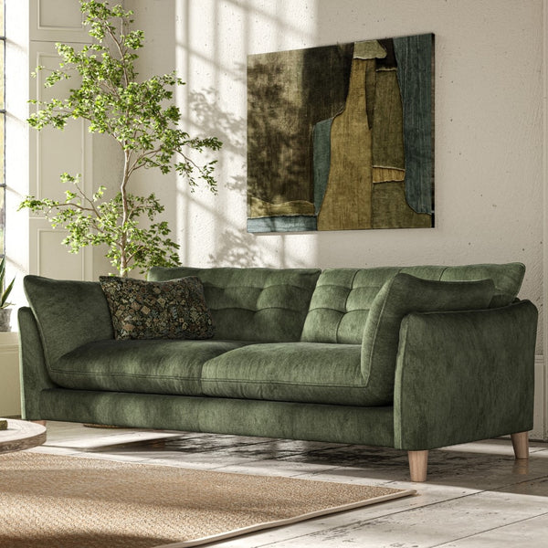 Green fabric cushion sofa with wooden feet, in a living room